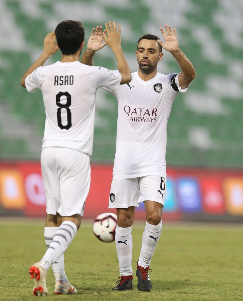 Al Sadd’s saviour, Ali Asadallah celebrates with skipper Xavi Hernandez after scoring their third goal against Al Sailiya during their QSL Cup match played at the Hamad Bin Khalifa Stadium yesterday.

