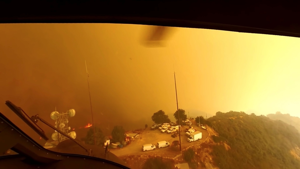 Helicopter pilots look for a landing spot during a rescue made on the fly during the Woolsey Fire in Malibu, California, in this November 9, 2018 still image taken from helmet camera footage by LAFD David Nordquist. LAFD/David Nordquist/Social Media/via R