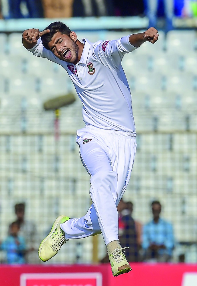 Bangladesh cricketer Nayeem Hasan celebrates after the dismissal of the West Indies cricketer Kemar Roach during the second day of the first Test cricket match between Bangladesh and West Indies at the Zahur Ahmed Chowdhury Stadium in Chittagong on Novemb