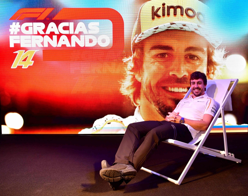 McLaren's Spanish driver Fernando Alonso poses for photographers during his farewell party at the Yas Marina circuit on November 24, 2018, in Abu Dhabi, ahead of the Abu Dhabi Formula One Grand Prix. / AFP / Andrej ISAKOVIC