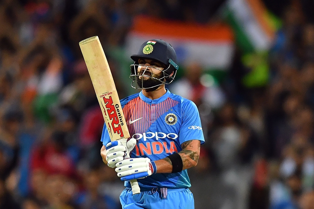 India's batsman Virat Kohli celebrates as he completes his 50-runs during a T20 international cricket match against Australia at the SCG in Sydney on November 25, 2018. (AFP / Saeed KHAN)