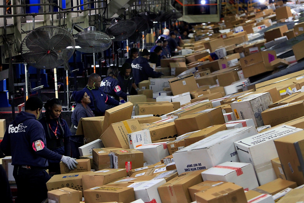 FedEx personnel sort boxes at the company's Memphis World Hub during the company's busiest overall volume night of the year in Memphis, Tennessee, US, December 15, 2009. Reuters/Lance Murphey