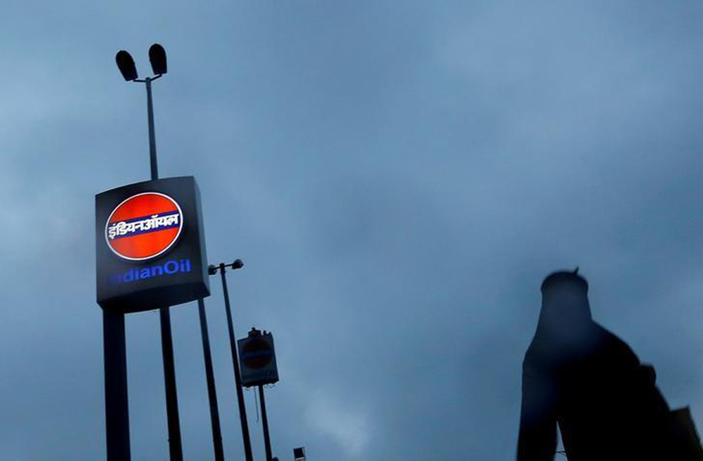 File photo of a woman walking past a logo of Indian Oil outside a fuel station in New Delhi, India, August 29, 2016. REUTERS/Adnan Abidi/File photo