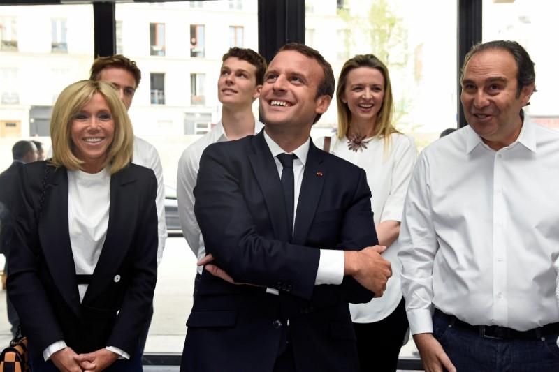 France's President Emmanuel Macron and his wife Brigitte speak with French entrepreneur and businessman Xavier Niel (R) during the inauguration of start-ups incubator 