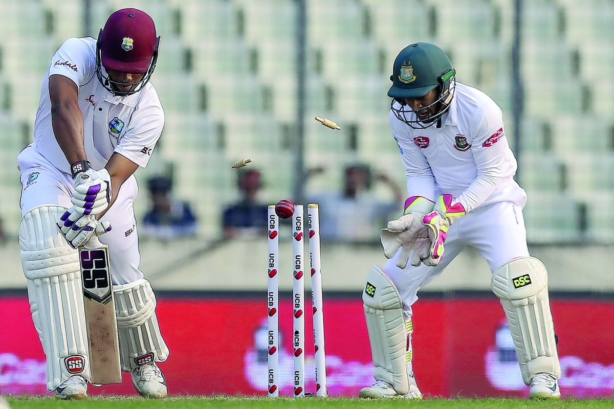 West Indies' Kieran Powell (L) is bowled out during the second day of the second Test cricket match between Bangladesh and West Indies in Dhaka on December 1, 2018. AFP / Salahuddin Ahmed 