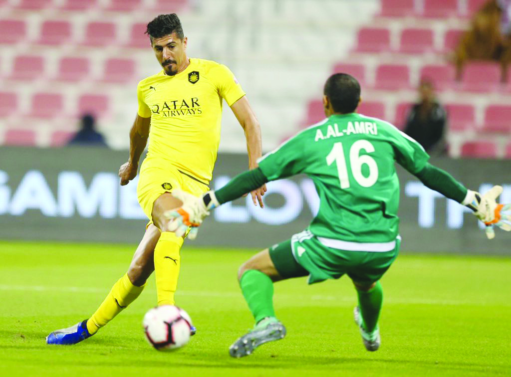 Al Sadd’s Baghdad Bounedjah (left) scores past Al Shahaniya goalkeeper A. Al Amri during their QNB Stars League match played at the Al Duhail Stadium yesterday.