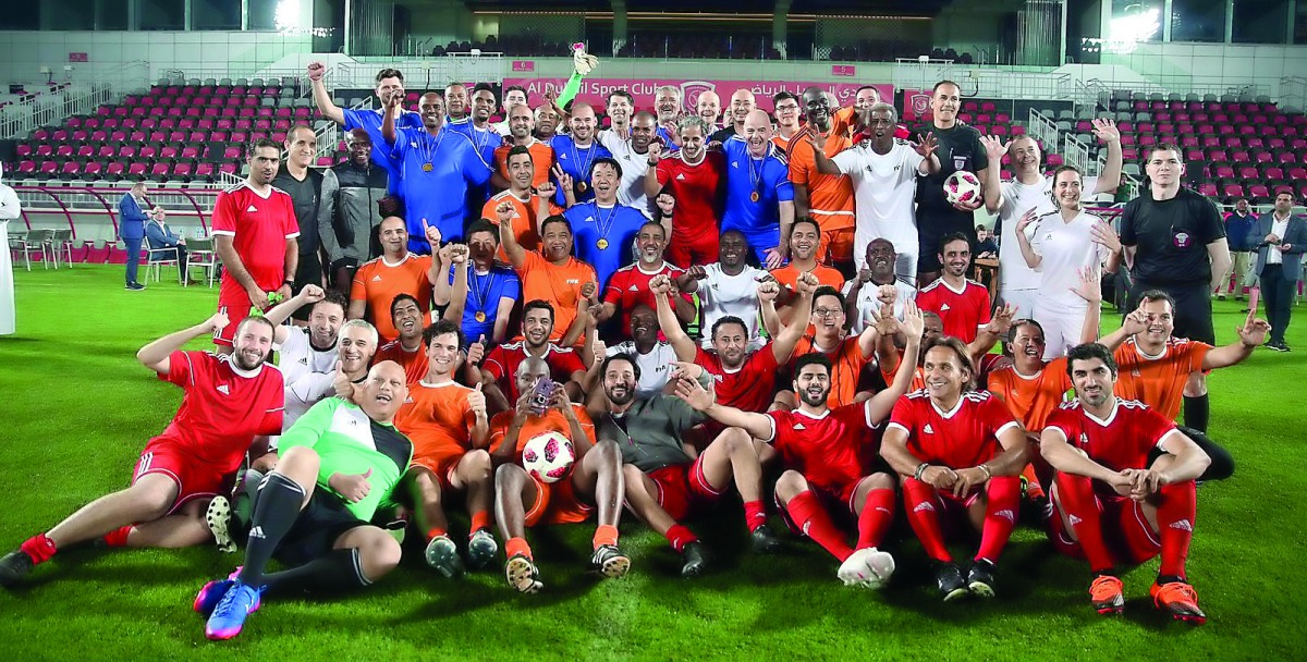 Qatar Football Association President Sheikh Hamad bin Khalifa bin Ahmed Al Thani and FIFA President Gianni Infantino pose for a photograph with participating players and officials following a friendly football tournament which took place at the Al Duhail 