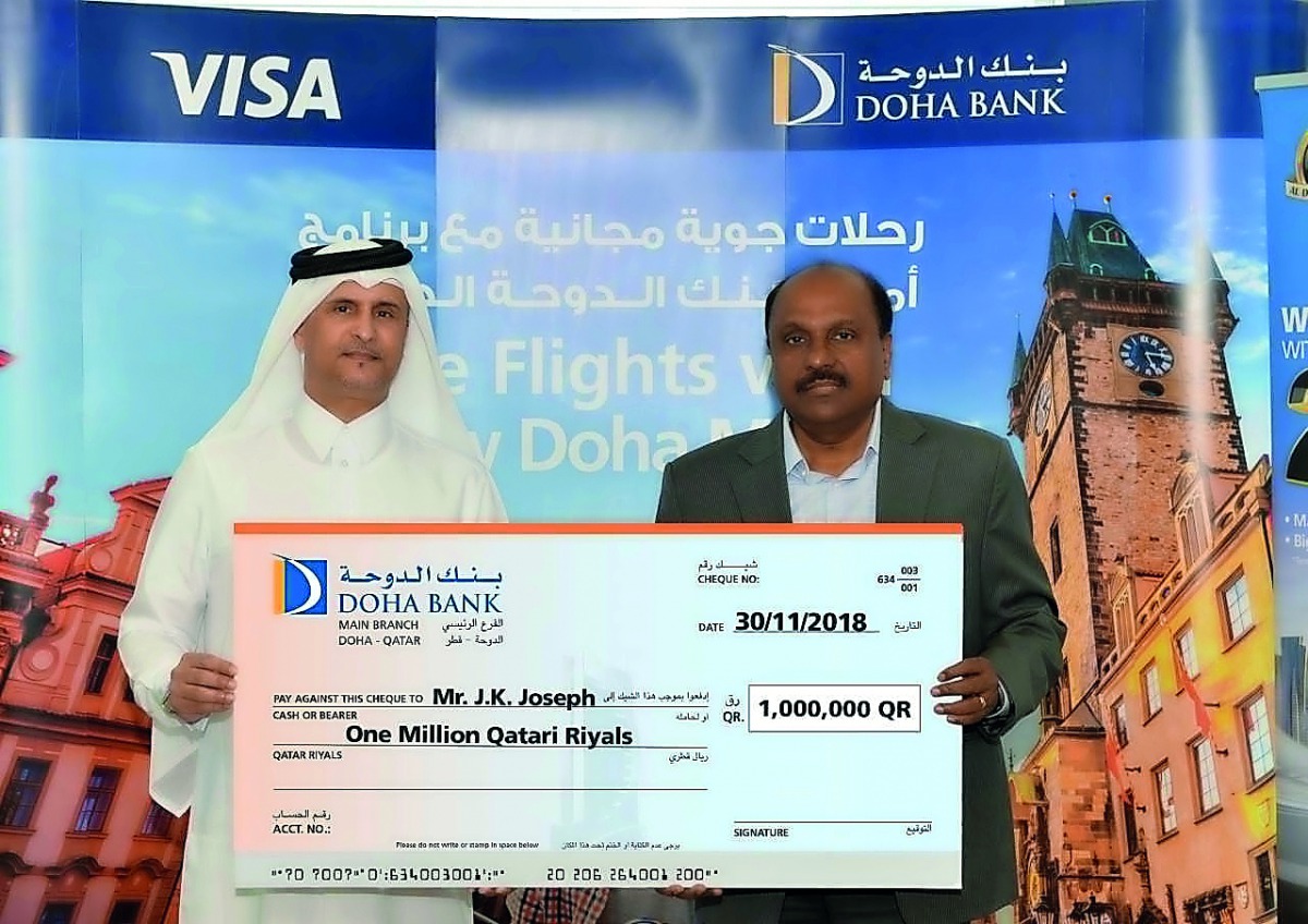 Lucky winner J K Joseph receiving the cheque from Doha Bank official. 