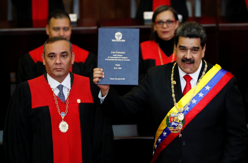 Venezuela's President Nicolas Maduro is sworn in by Venezuela's Supreme Court President Maikel Moreno, during the ceremonial swearing-in for his second presidential term, at the Supreme Court in Caracas, Venezuela January 10, 2019. Reuters/Carlos Garcia R