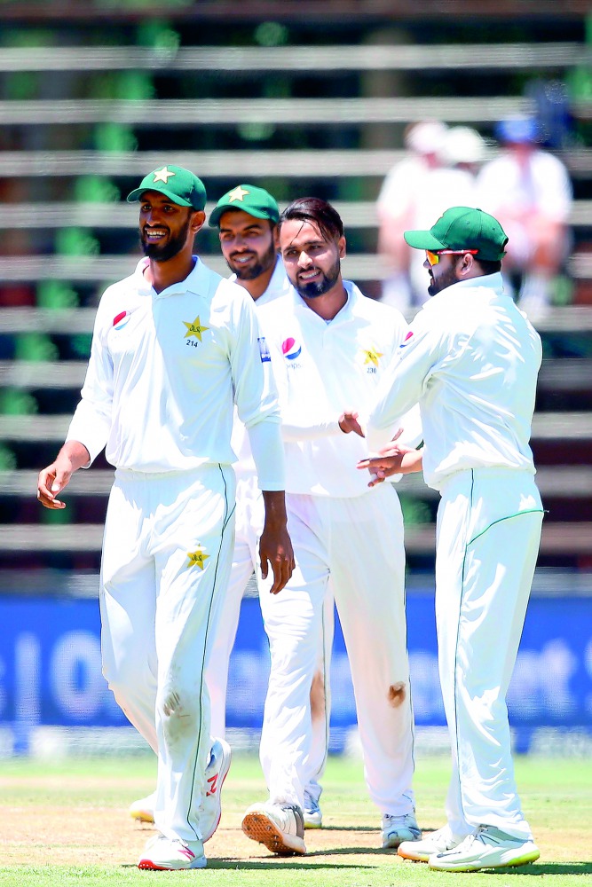 Pakistan bowler Faheem Ashraf (CR) celebrates the dismissal of South African batsman Aiden Markram (not in picture) during the first day of the third Cricket Test match between South Africa and Pakistan at Wanderers cricket stadium on January 11, 2019 in 