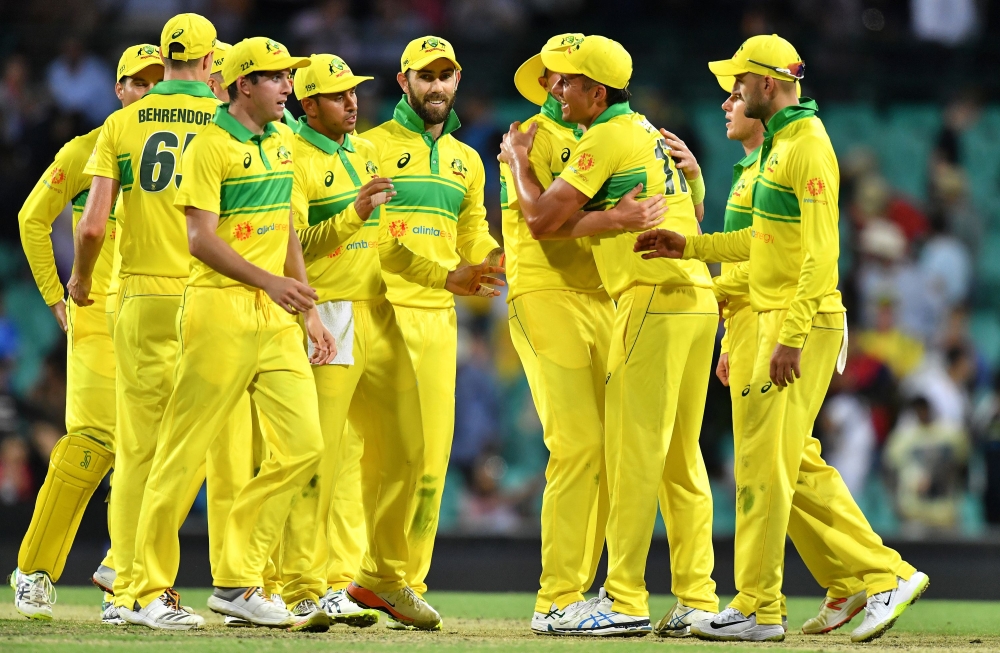 Australia's players celebrate their victory over India in the first one-day international (ODI) match at the Sydney Cricket Ground in Sydney on January 12, 2019. (AFP / Saeed Khan)