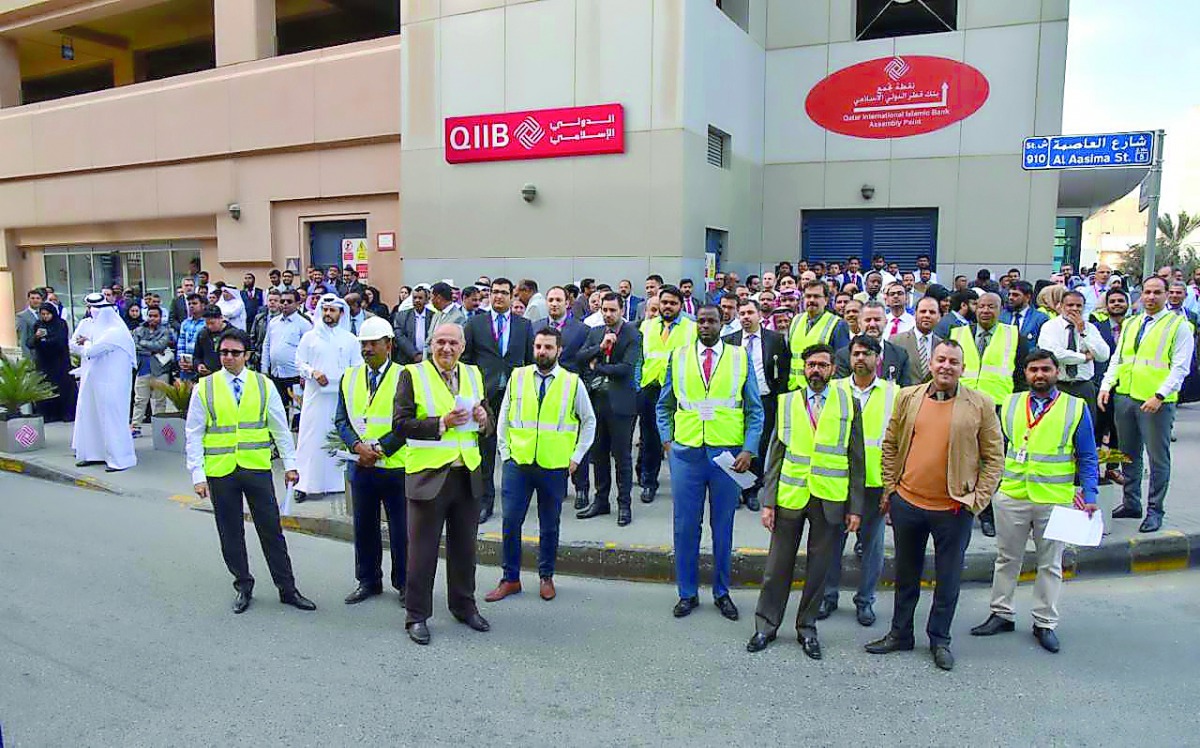 QIIB staff and  Civil Defense and Emergency Medical Service personnel seen assembled in front of QIIB building on Grand Hamad Street.