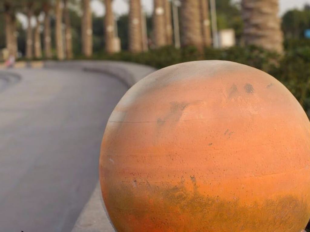A teaser released by the QU showed a model of Mars at the MIA park. 