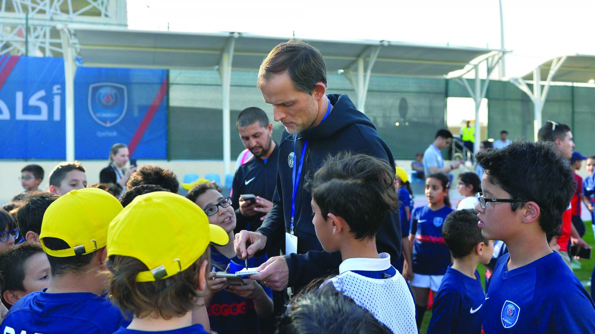 PSG coach Thomas Tuchel signs autographs for fans during the Qatar Tour 2019.  