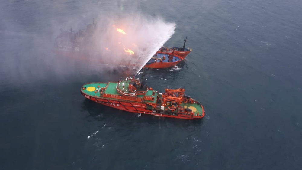 An aerial view from a helicopter shows a rescue vessel during a fire-fighting operation following an accident involving two ships, which caught fire in the Kerch Strait near the coast of Crimea in this handout photo released by Russian Emergencies Ministr