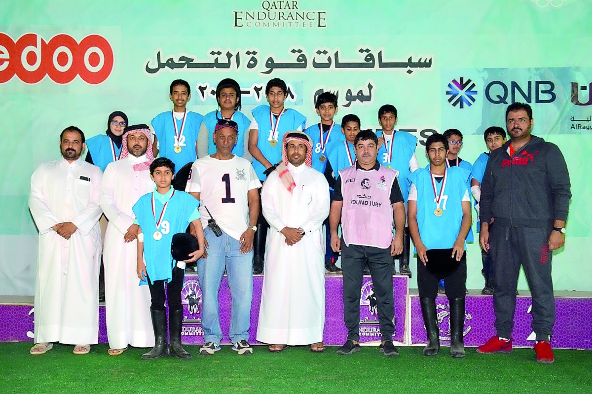 Young riders pose with the officials after taking part in the 20km Endurance Race which was held at Sealine on Friday. 