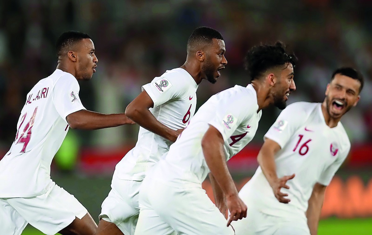 Qatari players celebrate their victory against South Korea.