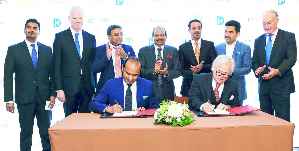 Adeeb Ahamed (sitting left), Managing Director, Twenty14 Holdings signing the agreement with Necron AG CEO Gerard van Liempt to develop the IntercityHotel Zurich Airport, in the presence of Yusuff Ali MA, Chairman and Managing Director, LuLu Group Interna