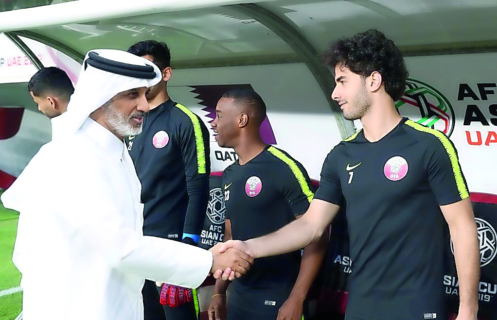Sheikh Hamad bin Khalifa bin Ahmed Al Thani, Qatar Football Association (QFA) President, shakes hands with Ahmed Alaaeldin during a practice session which took place in Abu Dhabi, yesterday.