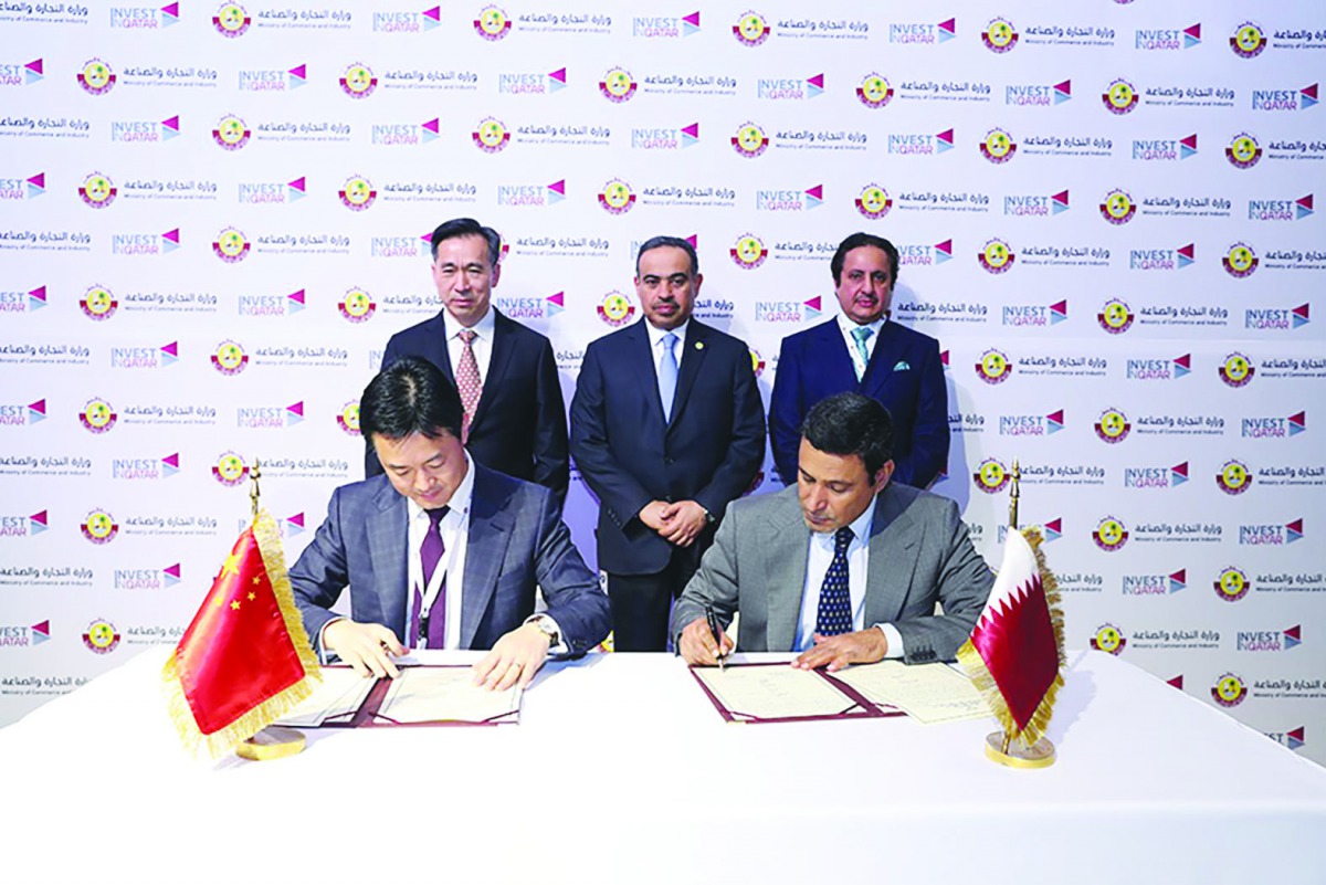 H E Ali bin Ahmed Al Kuwari (standing at the centre), Minister of Commerce and Industry, and Sheikh Khalifa bin Jassim Al Thani (standing right),Qatar Chamber Chairman, witnessing the signing of an agreement the sidelines of the Qatar-China Business Forum
