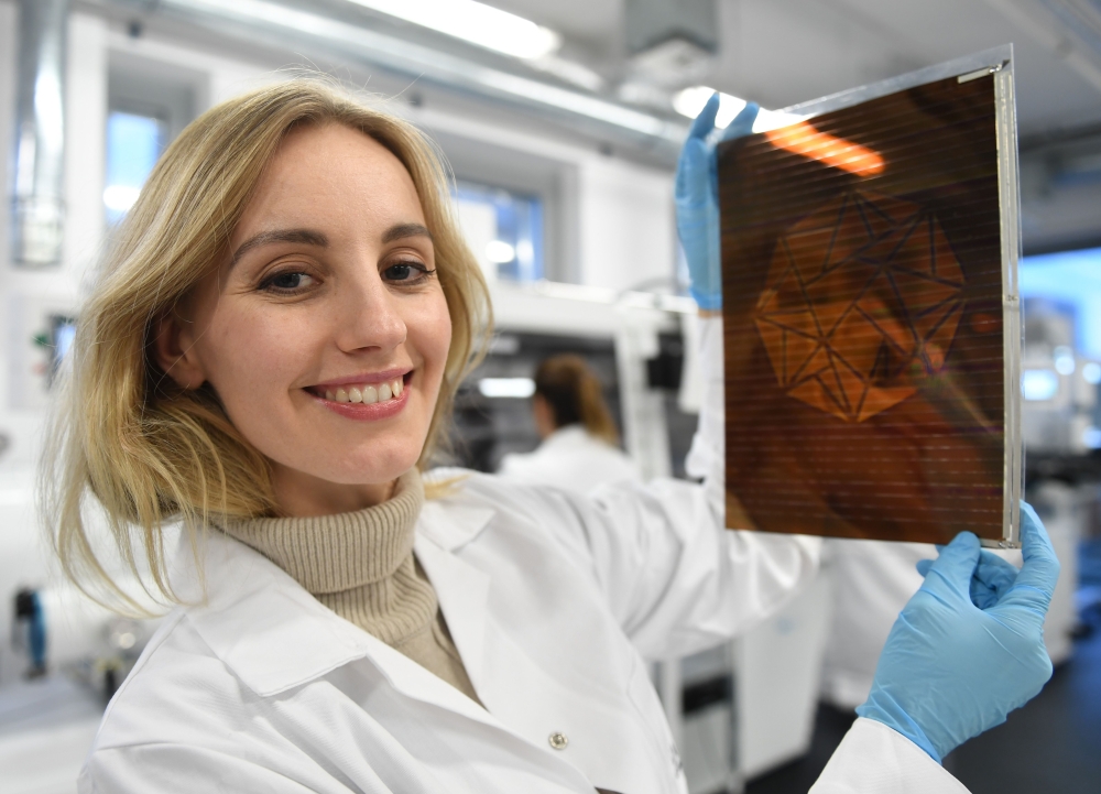 Polish physicist and businesswoman Olga Malinkiewicz poses with a printed solar panel at her company Saule in Wroclaw on January 16, 2019. AFP / Janek SKARZYNSKI