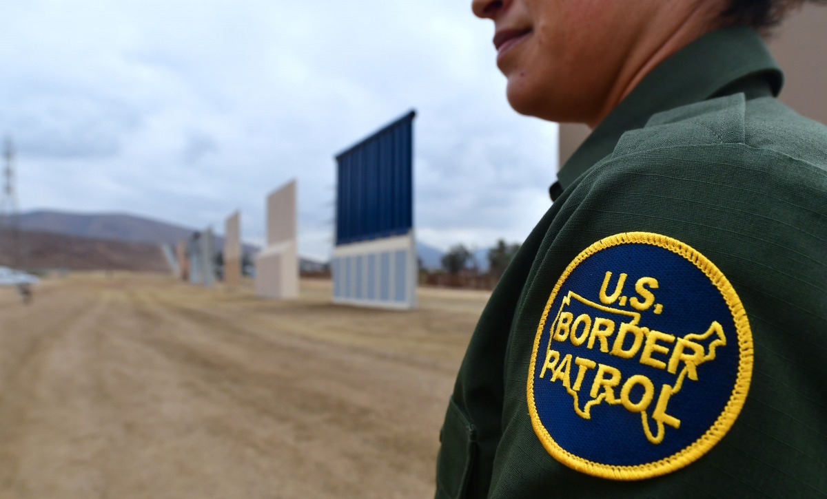 A US Border Patrol officer stands near prototypes of border wall proposed by US President Donald Trump on November 1, 2017 in San Diego. AFP/Frederic J Brown