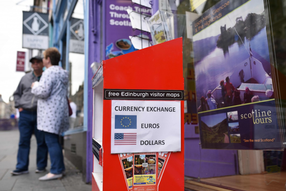 A travel agent on the Royal Mile offers a currency exchange service in Edinburgh on June 25, 2016 following the pro-Brexit result of the EU referendum vote. AFP