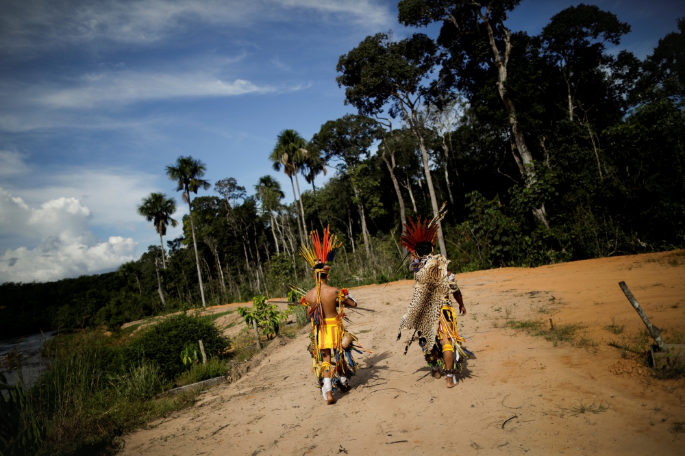 Indigenous people of the Pareci community walk in the village of Wazare near the town of Campo Novo do Parecis, Brazil, April 26, 2018. Reuters/Ueslei Marcelino