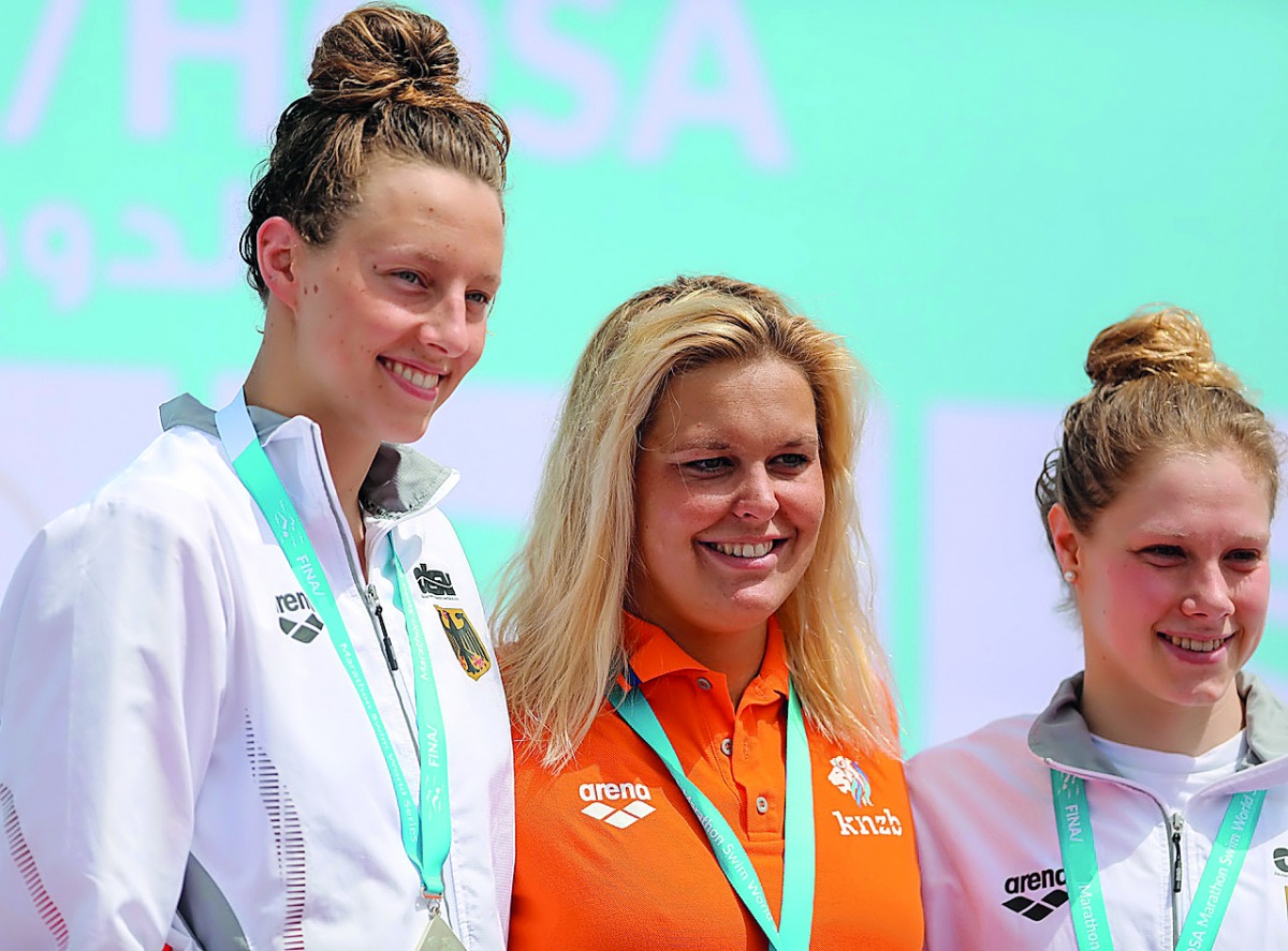 Dutch swimmer Sharon Van Rouwendaal (centre) will return to Doha this week to defend her title. 
