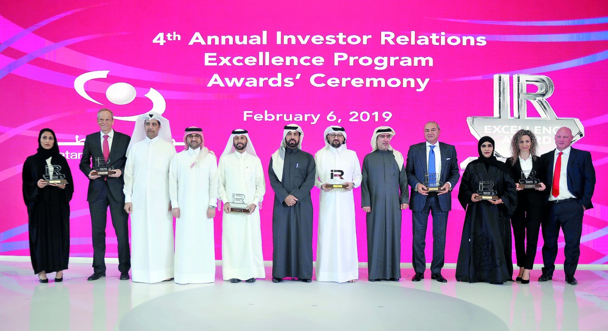 Rashid bin Ali Al Mansoori (sixth left), CEO of Qatar Stock Exchange, with the award winners at the annual award ceremony event. Pic: Abdul Basit / The Peninsula