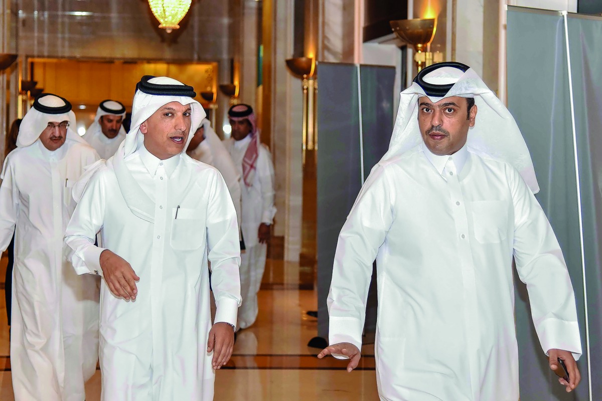 H E Ali Shareef Al Emadi, Chairman of the Board of Directors of QNB Group, who is also the Minister of Finance, being led by Abdulla Mubarak Al Khalifa (right), Acting Group CEO of QNB, to preside over the QNB Group’s Ordinary and Extraordinary General As