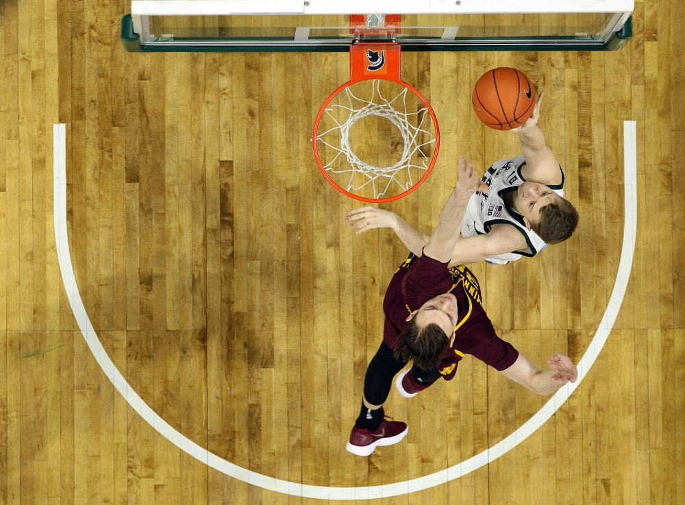 REPRESENTATIONAL IMAGE: Michigan State Spartans forward Thomas Kithier (top) shoots against Minnesota Golden Gophers center Matz Stockman (bottom) during the first half at the Breslin Center. Credit: Mike Carter-USA TODAY Sports 
 