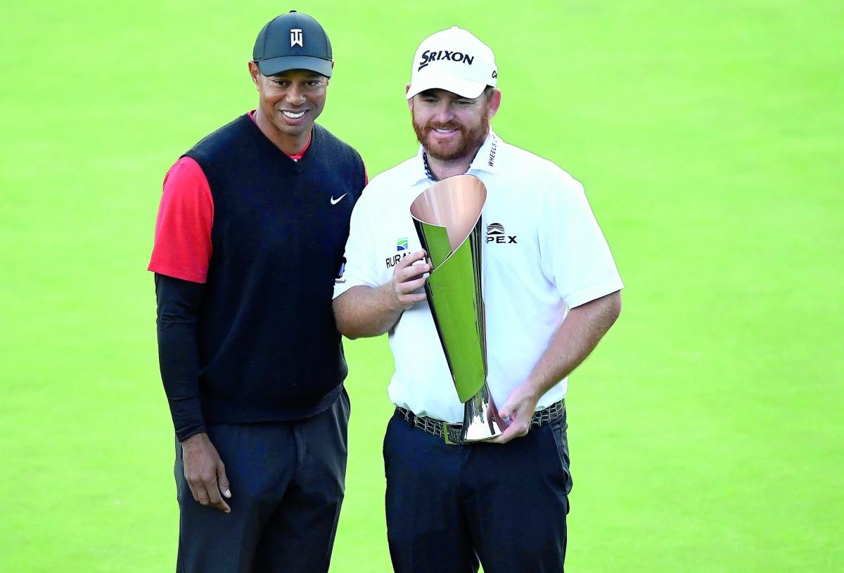 JB Holmes poses for photos with Tiger Woods following his victory of the Genesis Open golf tournament at Riviera Country Club. Credit: Gary A. Vasquez-USA TODAY Sports 
