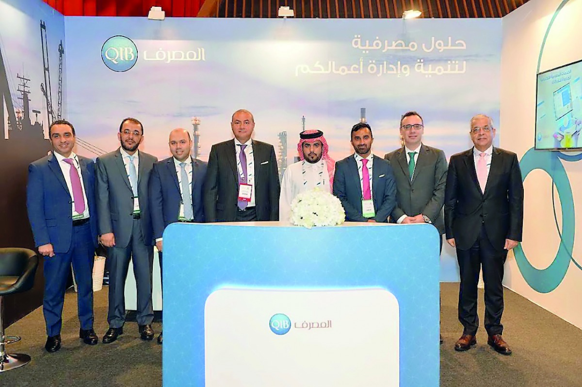 QIB’s Group CEO Bassel Gamal and senior executives at the bank’s pavilion put-up at Tawteen Exhibition & Conference, yesterday.