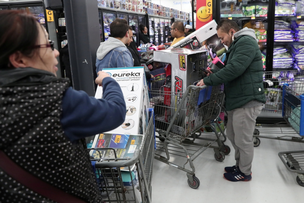 People wait in line pay at a Walmart during a sales event on Thanksgiving day in Westbury, New York, U.S., November 22, 2018. Reuters/Shannon Stapleton