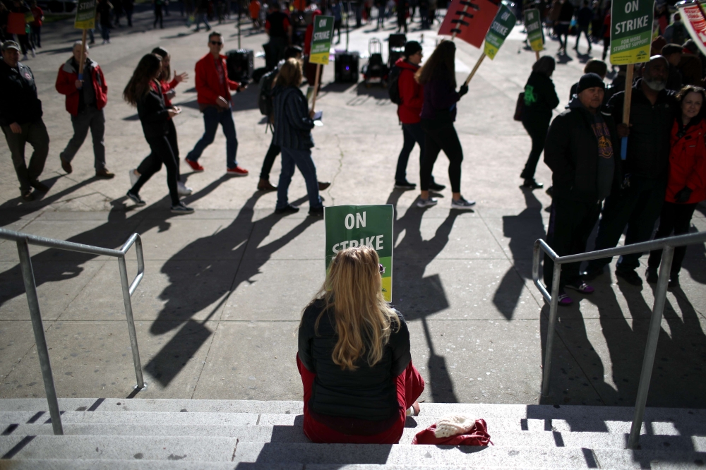 Oakland Unified School District students and teachers carry signs as they picket outside of Oakland Technical High School on February 21, 2019 in Oakland, California. Nearly 3,000 teachers in Oakland have gone on strike and are demanding a 12 percent retr