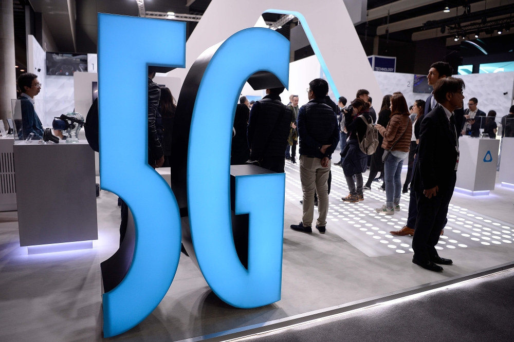 A 5G sign is displayed at a stand at the Mobile World Congress (MWC) in Barcelona on February 25, 2019. AFP / Josep Lago 