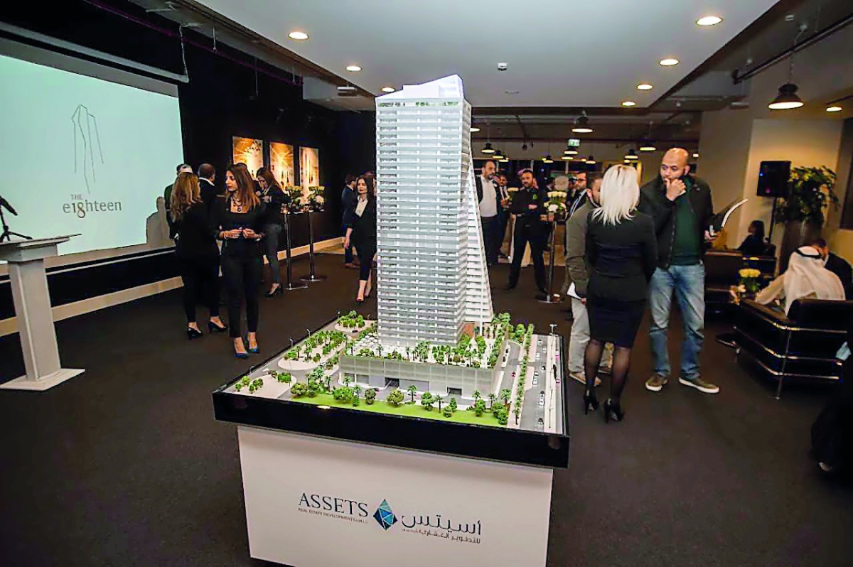 Guests pass by the replica of e18hteen Tower during the event.