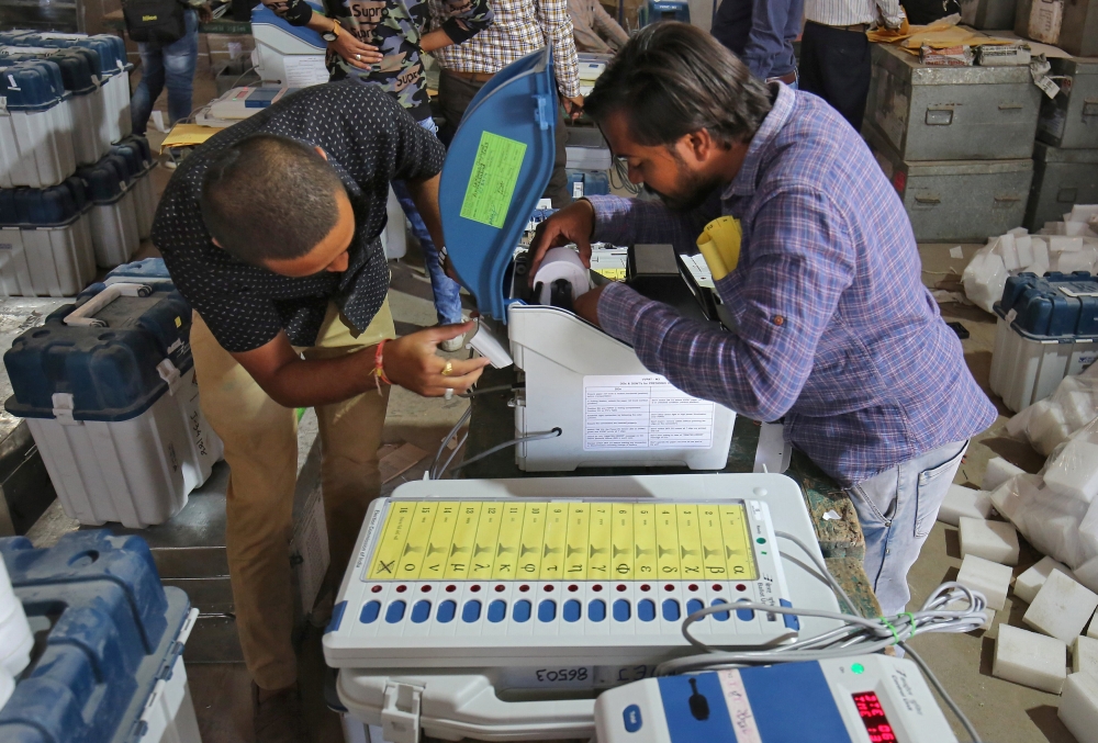 Election staff prepare Voter Verifiable Paper Audit Trail (VVPAT) machines and Electronic Voting Machines (EVM) ahead of India's general election at a warehouse in Ahmedabad, India, March 6, 2019. Reuters/Amit Dave