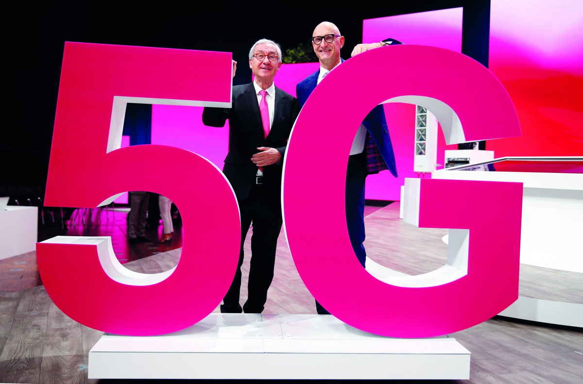 Timotheus Hoettges, CEO of Deutsche Telekom AG and Ulrich Lehner, chairman of the supervisory board, pose behind a 5G logo during the company's annual shareholders meeting in Bonn, Germany March 28, 2019. Reuters/Wolfgang Rattay