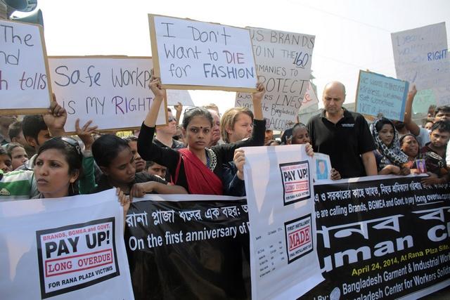 Protesters and activists hold placards on the first year anniversary of the collapse of Rana Plaza as they gather in Savar April 24, 2014. Reuters/Andrew Biraj