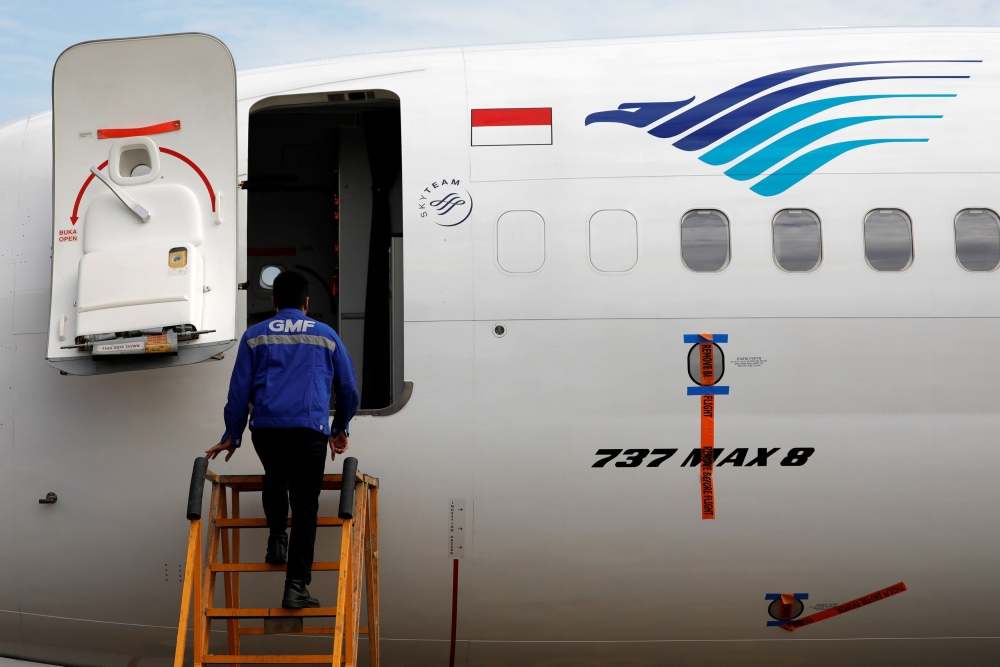 A technician prepares to check Boeing 737 Max 8 airplane of Garuda Indonesia parked at the Garuda Maintenance Facility AeroAsia at Soekarno-Hatta International airport, March 13, 2019. Reuters/Willy Kurniawan