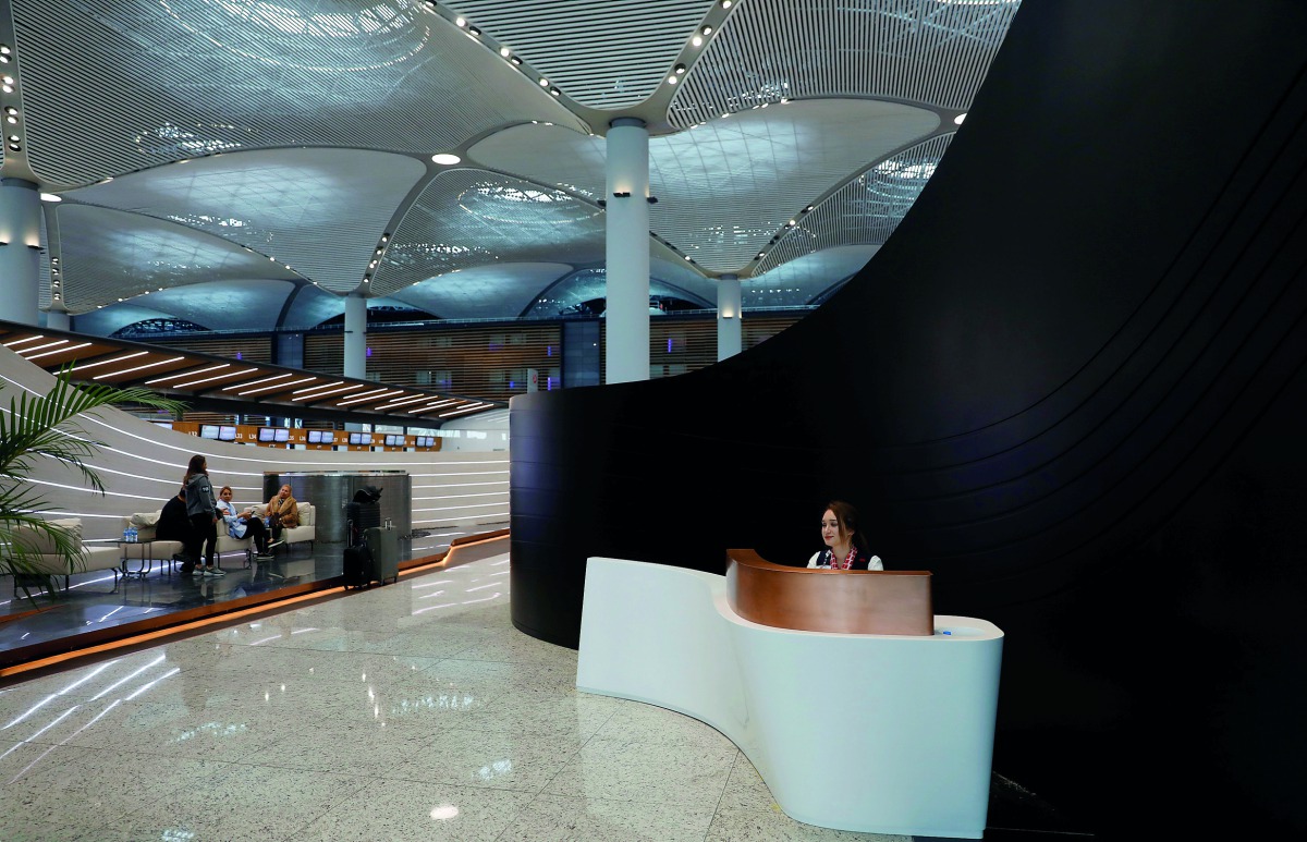 A receptionist waits for passengers at the entrance of Turkish Airlines business class check-in hall at the city’s new Istanbul Airport in Istanbul, Turkey.