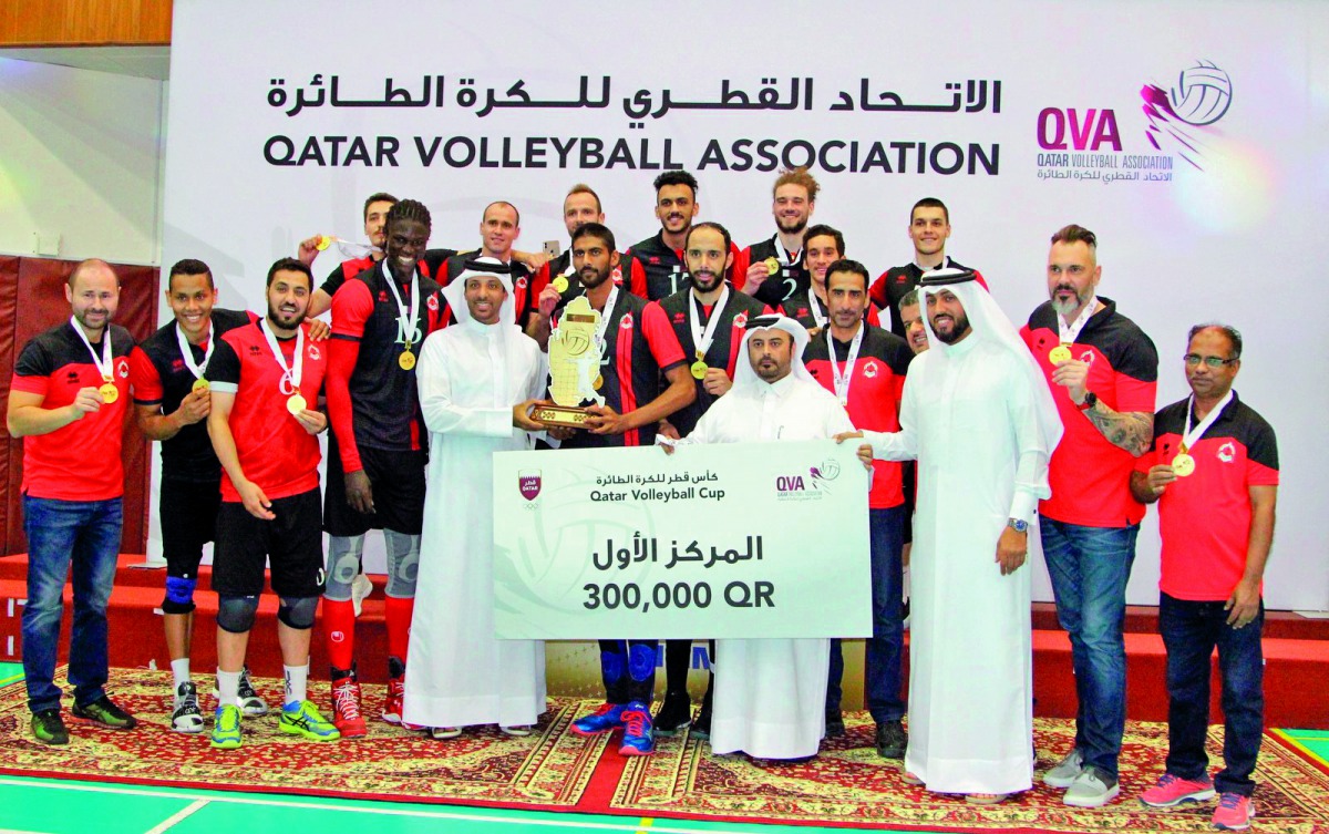 The players and officials of Al Rayyan pose for a picture during the victory ceremony, after winning the Qatar Cup in Doha yesterday.
