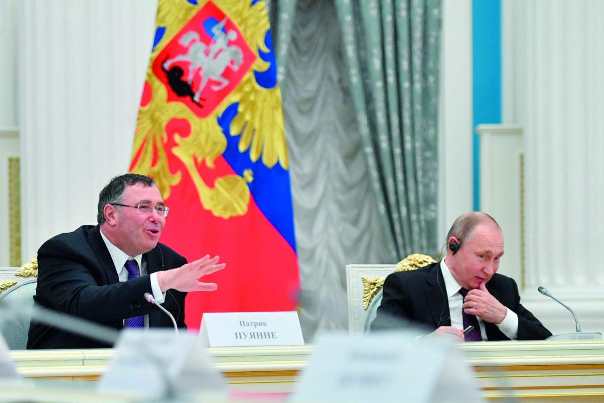Russian President Vladimir Putin (R) listens to Total CEO Patrick Pouyanne during a meeting with French business leaders at the Kremlin in Moscow on April 18, 2019. AFP / pool / Alexander Nemenov
