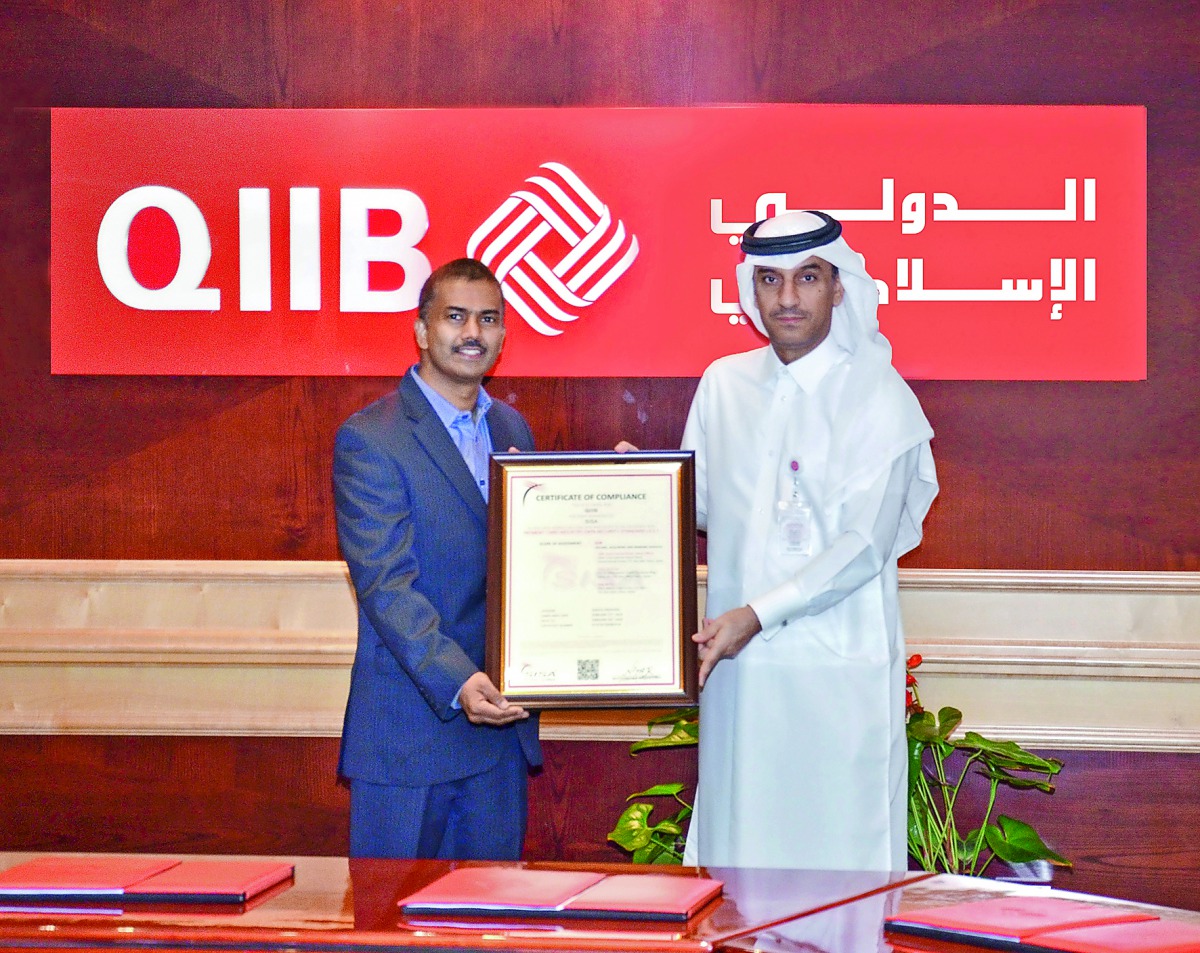 QIIB Deputy CEO, Jamal Abdullah Al Jamal (right), receiving the certificate at a ceremony held at the Bank’s headquarters in Grand Hamad Street, yesterday.
