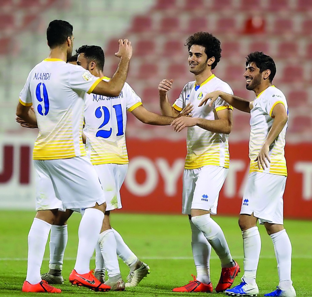 Al Gharafa’s Mehdi Taremi (left) is congratulated by team-mates after the Iranian forward scored their fifth goal against Al Khor in yesterday’s Amir Cup match.