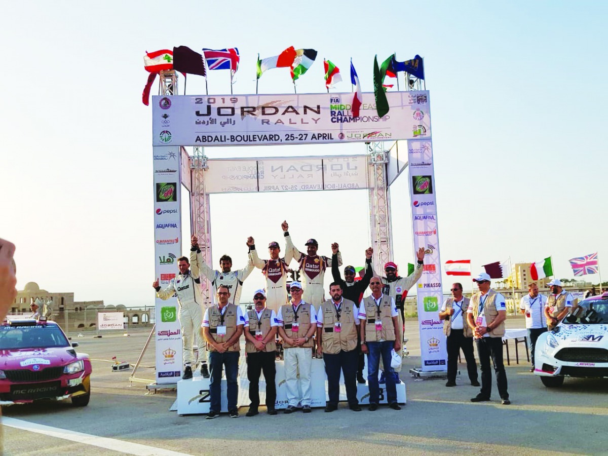 Qatar’s Nasser Saleh Al Attiyah and his French co-driver Matthieu Baumel celebrate with podium winners and officials after winning the Jordan Rally, yesterday.