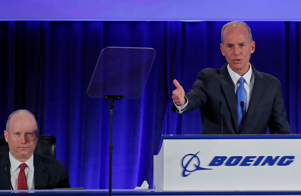 Boeing Co Chief Executive Dennis Muilenburg speaks, as Boeing Vice-President and Corporate Secretary Grant Dixton (L) looks on, during the general annual shareholder meeting at the Field Museum in Chicago, Illinois, U.S., April 29, 2019. Jim Young/Pool vi