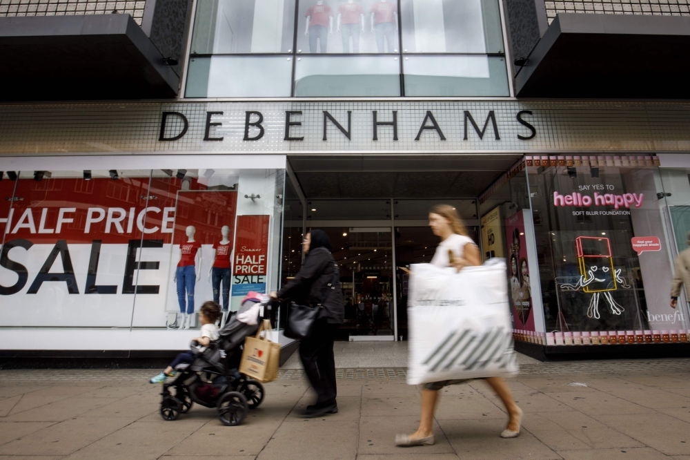 In this file photo taken on June 19, 2018 Shoppers walk past a Debenhams shop in Oxford Street, central London on June 19, 2018. AFP / Tolga Akmen 
 